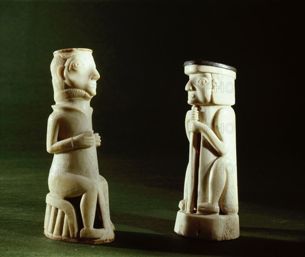 Two carved ivory figures depicting Europeans