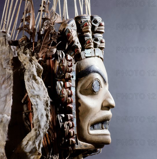 Chiefs headdress with humanoid face surrounded by a row of abalone shell and a double row of smaller faces