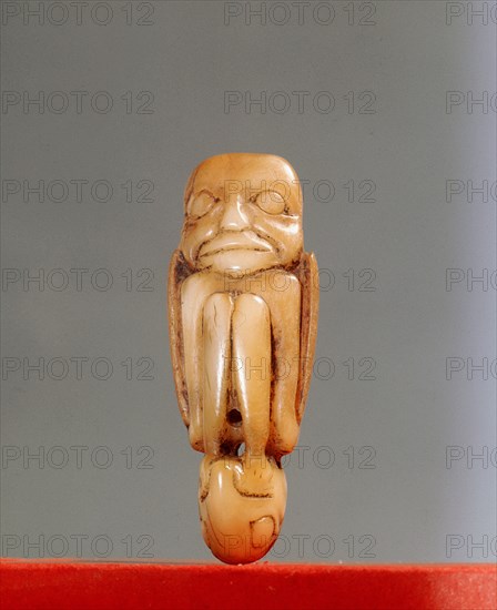 Shamans charm, cut from canine teeth in the form of a foetal human