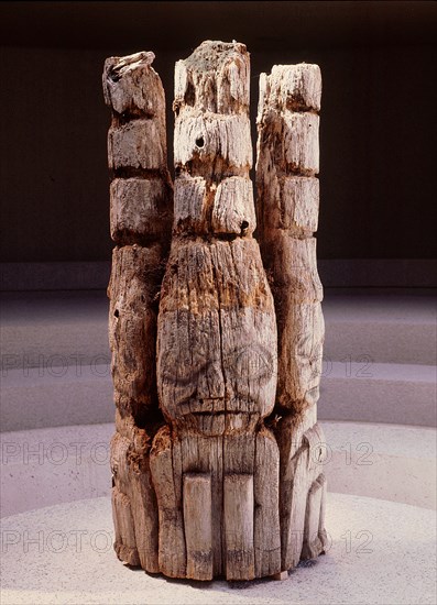 The top section of a Haida house frontal pole depicting three watchmen