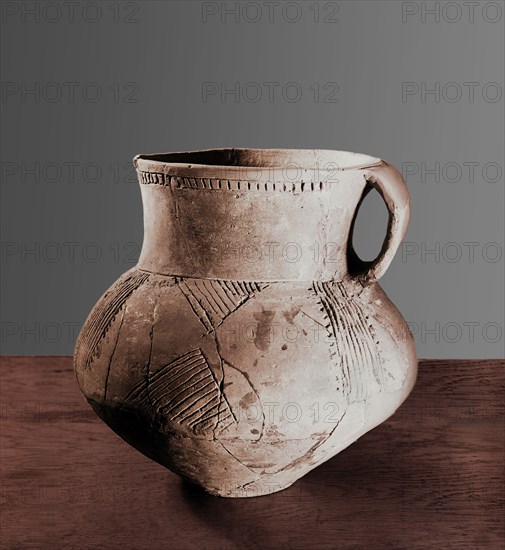 Jug with broad handle and insiced decoration