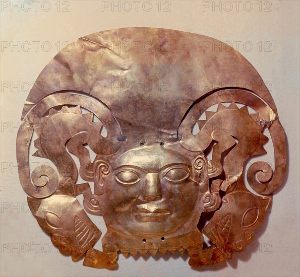 Beaten gold mask in the form of an anthropomorphic body with a large central face