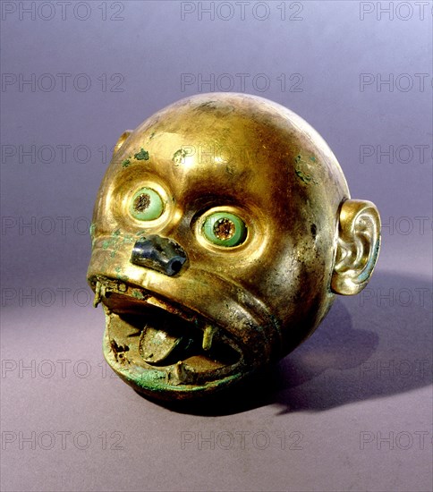 Gold monkey head bead which is typical of the elaborate funerary goods buried with Mochica nobility