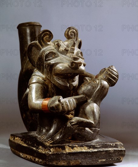 This is almost certainly a sacrifice scene, where the sacrifice is being carried out by a man wearing a feline mask