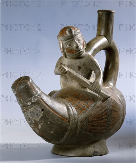 Stirrup spouted effigy showing a Mochica fisherman paddling a small totora reed boat