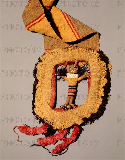 This elaborate belt shows a buckle made of tapestry in the form of a doll like figure