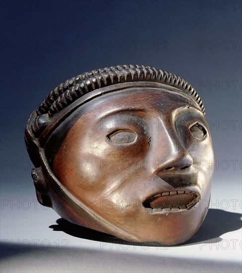 A vase in the form of a trophy head