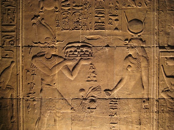 Relief from the inner sanctum of the temple of Isis depicting a pharaoh offiering gifts to the goddess