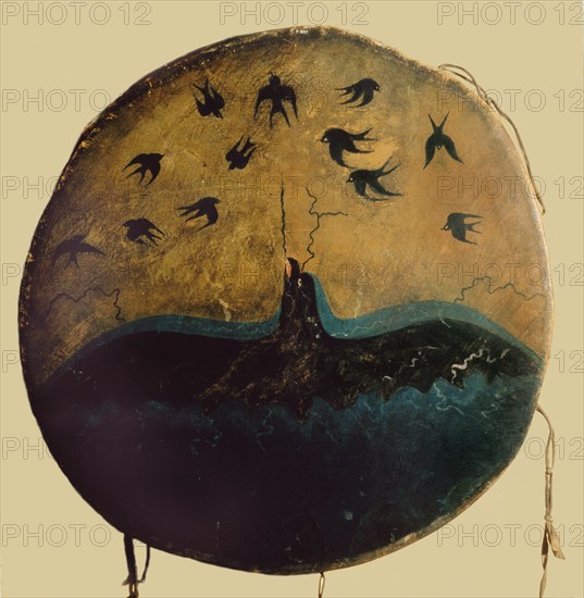 A thunderbird, mythical creator of Plain storms, swoops out of the sky, hurling lightning flashes at darting swallows on this graphic Pawnee ceremonial drum