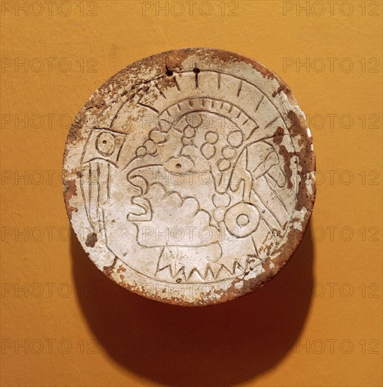 Shell gorget incised with a man with a Southern Cult headdress and ear plugs