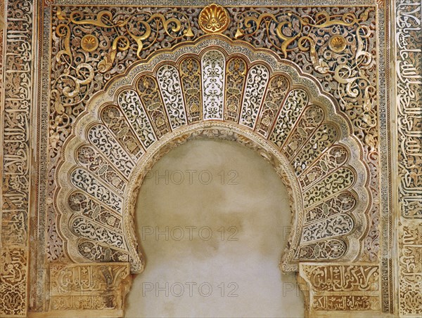 Elaborate decoration in the form of inscriptions and arabesques above an arched niche