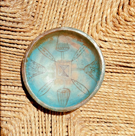 Bowl with faience interior incised with design including lotus buds