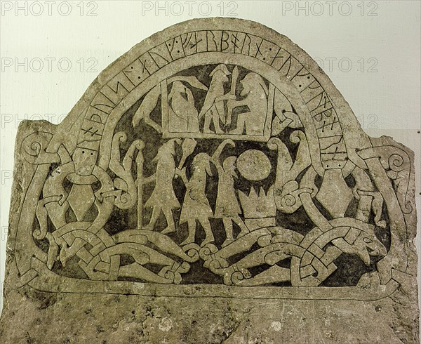 Picture stone with runic writing across the top