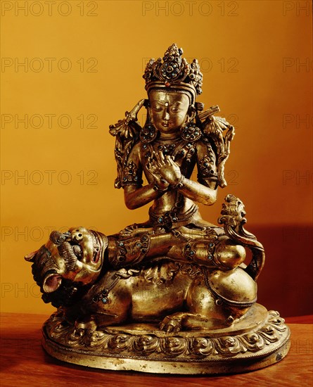 A statue of Manjusri, Bodhisattva of Wisdom, with the sword that destroys ignorance on the lotus at his right shoulder, and the book of wisdom at his left