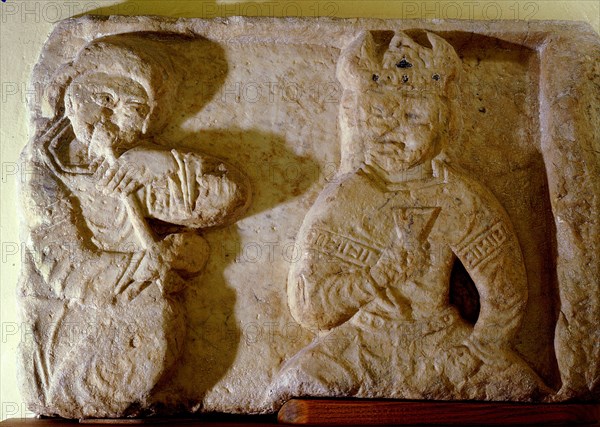 A marble relief from the Fatimid fortress city of Mahdia depicting a monarch with a musician playing a pipe
