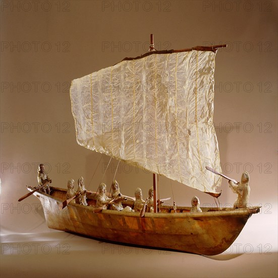 Model umiak with a helmsman and members of his family manning the oars