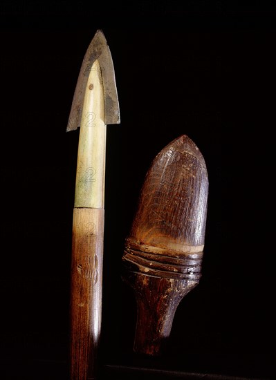 Tip of a lance and the wooden sheath used to protect it