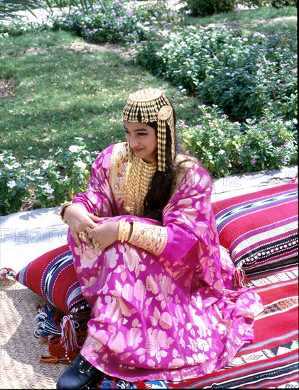 Young woman wearing an elaborate silver headdress of the type used for wedding ceremonies