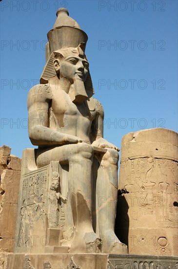 Seated figure of Rameses II wearing the double crown of Upper and Lower Egypt