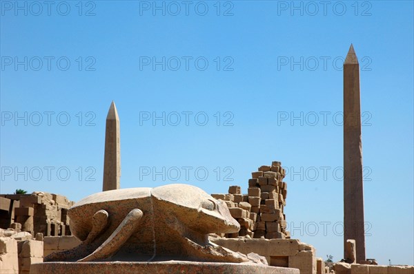 Giant scarab beetle sculpture at the edge of the sacred lake