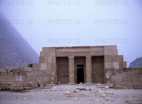 Near the southeast corner of the pyramid of Cheops stands the restored columned portico of the family tomb of Seshemnefer