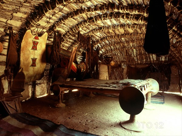 An interior of a tent 'house' with a large bed