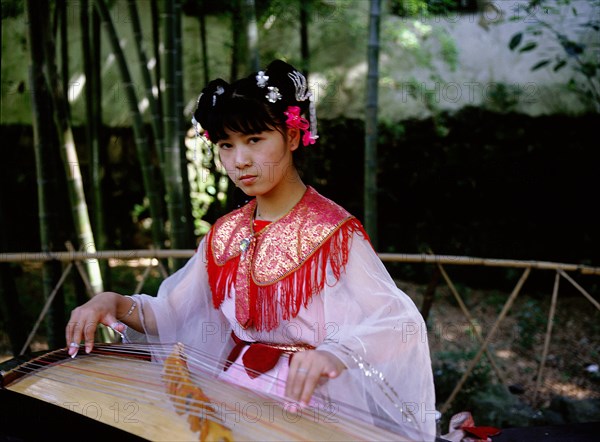 Instrument of ancient design played by a female musician dressed in Song style