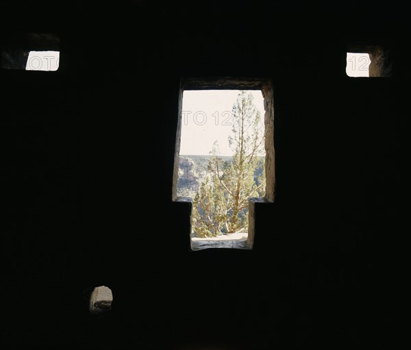 The dark interior of a cliff dwelling at Mesa Verde with typical 'keyhole' door