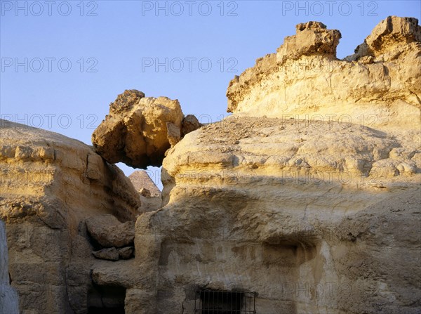 The Great Pyramid of Cheops seen through the crumbling superstructure of the Old Kingdom mastabas