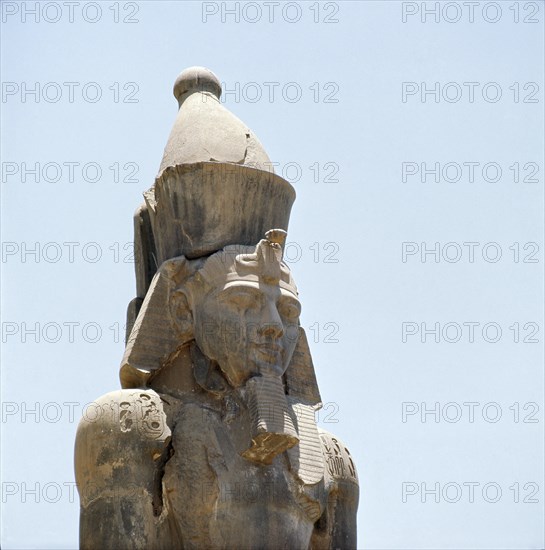 A colossal statue of Ramesses II wearing the double crown of Egypt