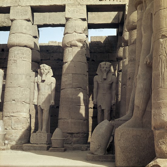 The First Courtyard with statues of Ramesses II, situated in front of the triple barque shrine dedicated to the gods Amun, Mut and Khons