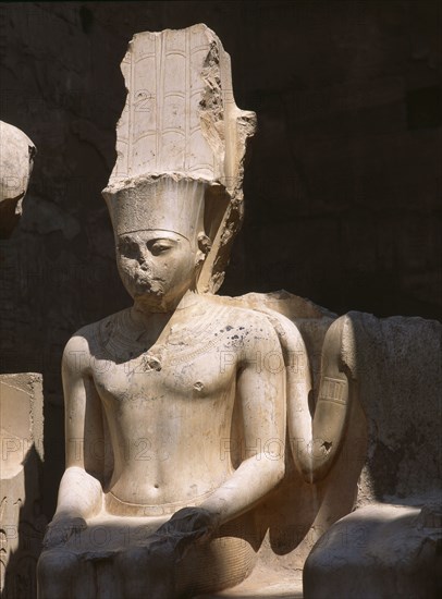 The South side of the processional colonnade of Amenophis III with seated double statues of the gods Amun and Mut