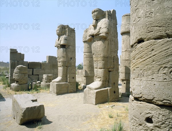 Two statues in the entrance of a corridor