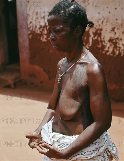 The wife of a Benin chief displays her body decorations