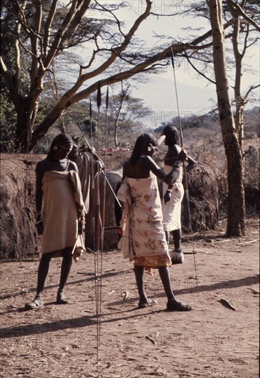 The hairstyle and beadwork of these Masai men indicate their status as warriors