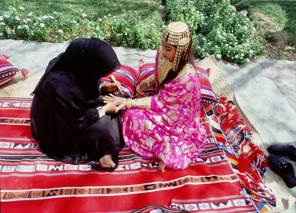 Geometric and floral decorative henna patterns were applied to adorn the hands and feet of young women on occasions such as weddings