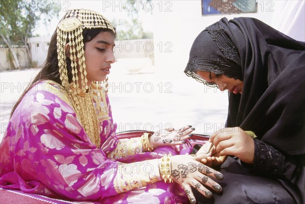 Geometric and floral decorative henna patterns were applied to adorn the hands and feet of young women on occasions such as weddings