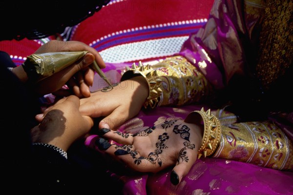 Geometric and floral decorative henna patterns were applied to adorn the hands and feet of young women on occasions such as weddings