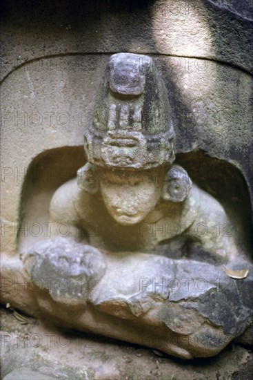 Olmec ruler in a stylised Jaguar mouth cave holding a baby deity