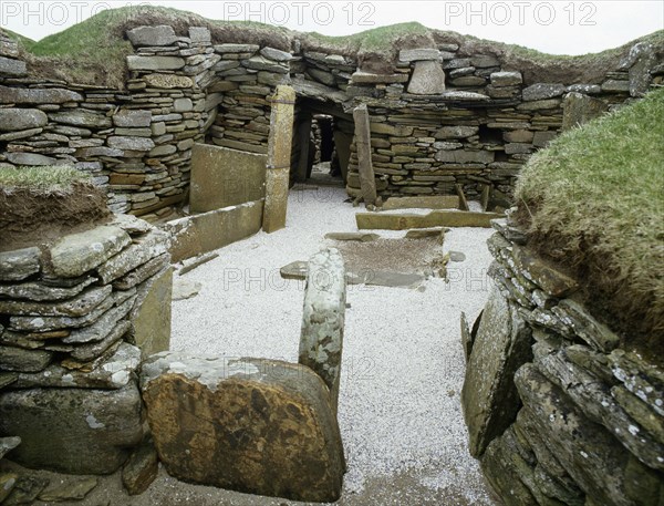 The interior of House 1, view of the hearth and the beds