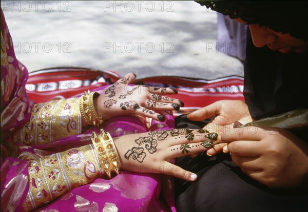 Geometric and floral decorative henna patterns were applied to adorn the hands and feet of young women on occasions such as weddings