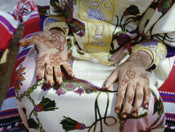 Geometric and floral decorative henna patterns were applied to adorn the hands and feet of young women on occasions such as weddings