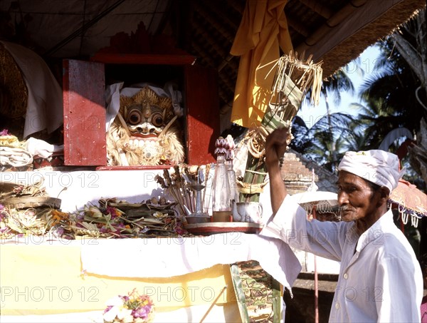 In the storehouse of the temple offerings are made to the spirits drawn into the masks