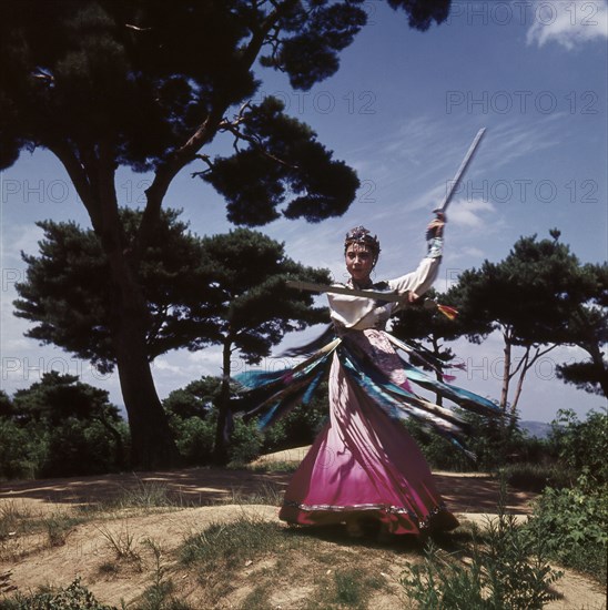 A dancer in a pink and purple robe