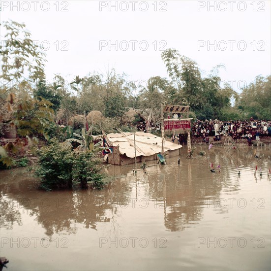 Villagers enjoy a play performed by water marionettes
