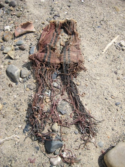 Coloured textile with tassles from a disturbed burial