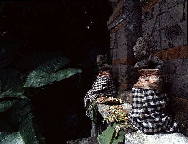 Divine gatekeepers at a small family temple dressed for a festival