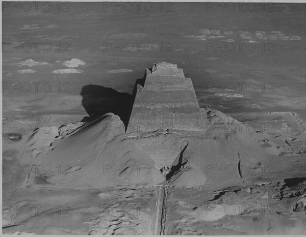 The pyramid of Meidum, surrounded by the debris of its collapsed outer covering, photographed in the 1920's