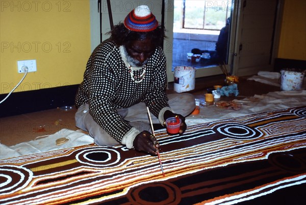 Balgo Community desert artist, the late Tjumpo Tjapanangka, working on a dot painting at the Warlayirti Culture Centre in the north-west desert region of Western Australia south of Halls Creek