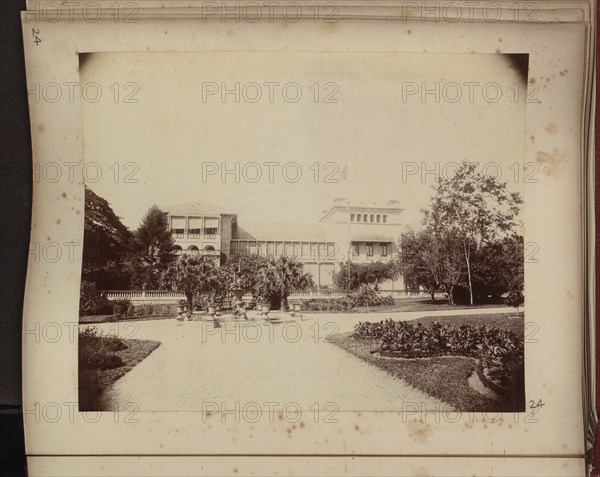 Large white house set in formal gardens